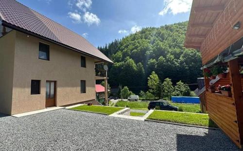 a view of a house and a driveway at Cabana Lazea in Arieşeni