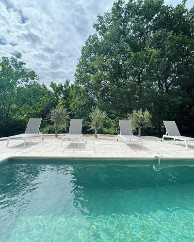 a group of chairs and a swimming pool at La maison d'HamiH "Gîte et Chambres d'hôtes in Uzès