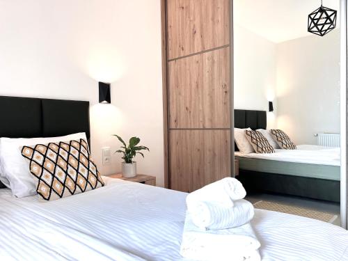 a bedroom with two beds with white sheets at Baltic Line - Zielona Wyspa in Sobieszewo