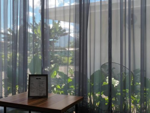 a table with a sign in front of a window at Villa Tanager in Fortuna