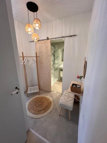 a hallway with a door leading into a room with a chair at Demeure du Mas de Bessac in Brengues