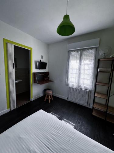 a bedroom with a white bed and a mirror at Contact Hotel Les Montois in Céaux