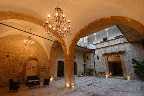 a large room with a chandelier in a building at Al Palazzo in Piazza Armerina