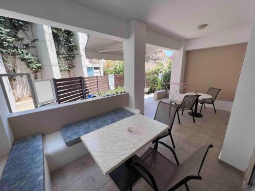 a patio with a table and chairs on a balcony at SCALA APARTS & STUDIOS - Rhodes in Afantou
