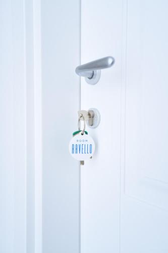 a sign hanging from a door with the word happyilda at Blue View Luxury Rooms in Furore