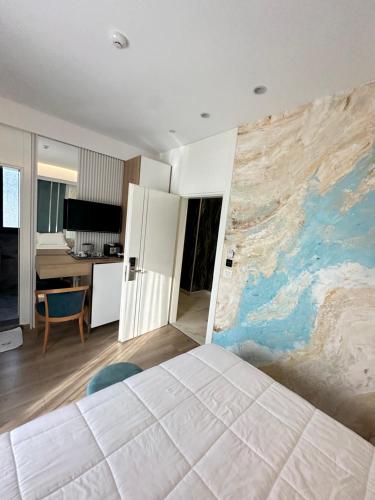 a bedroom with a large mural on the wall at Ilio Boutique Hotel in Ksamil