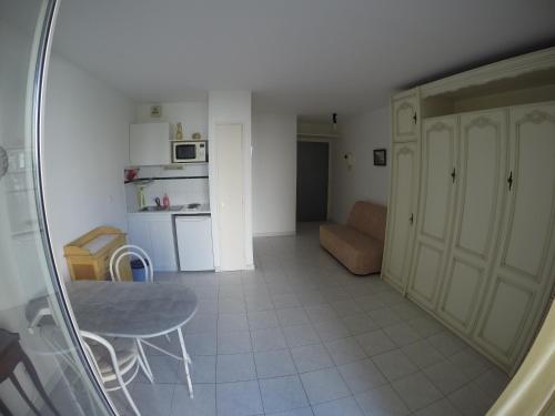 eine kleine Küche mit einem Tisch und einem Stuhl in einem Zimmer in der Unterkunft SANARY beau studio avec parking in Sanary-sur-Mer