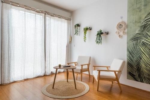 une pièce avec une table et deux chaises et une fenêtre dans l'établissement Le Bambou: Grand studio au calme, Climatisé, 5 min de la Gare, à Bordeaux