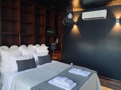 a bedroom with a large bed with towels on it at Casa Maramar in Angra do Heroísmo