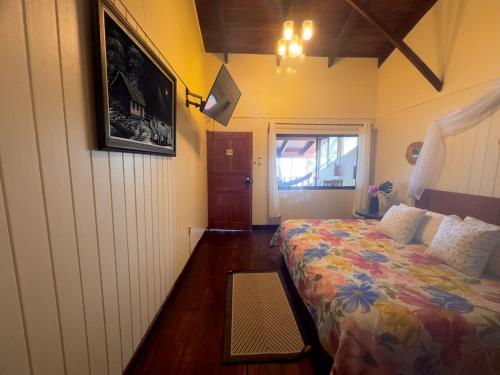a small bedroom with a bed and a window at Hotel Brasilito in Brasilito