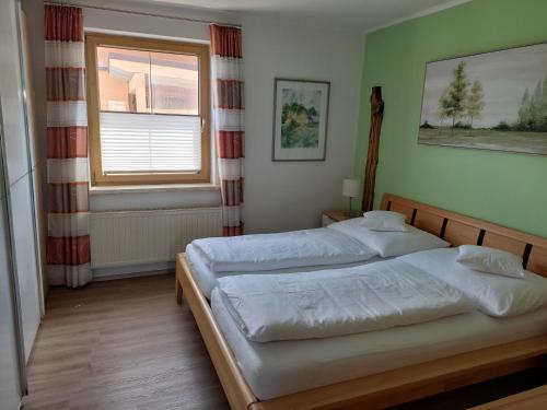 een slaapkamer met 2 bedden en een raam bij Wohnung mit Charme in Pinsdorf in Pinsdorf