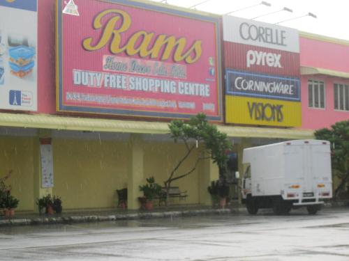 a white truck parked in front of a store at 1 Baron Motel in Kuah