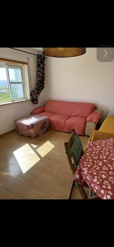 a living room with a red couch and a table at Ranjeet felizarda in Lisbon