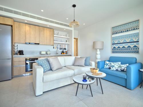 a living room with a couch and a table at Villa Le22, 180 panoramic sea views, Paros in Kampos Paros