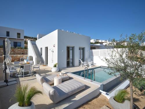 a villa with a swimming pool and a house at Villa Le22, 180 panoramic sea views, Paros in Kampos Paros
