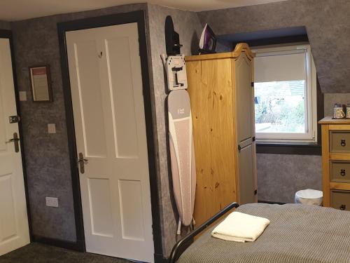 a bedroom with a bed and a white door at BELLFIELD HOUSE in Broadford