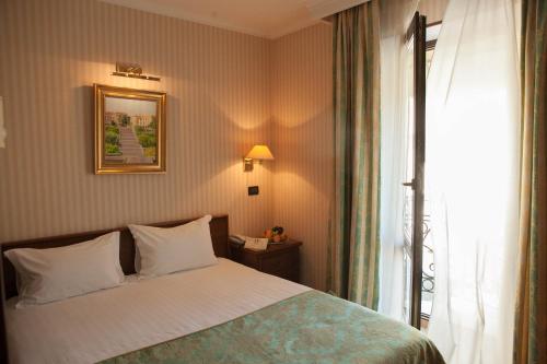 a hotel room with a bed and a window at Hotel Otrada in Odesa