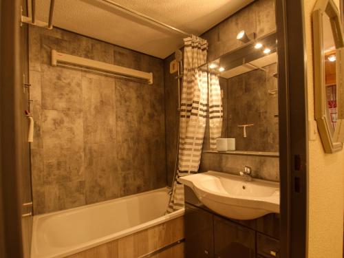 een badkamer met een wastafel, een bad en een wastafel bij Appartement Morillon Village, 3 pièces, 4 personnes - FR-1-642-54 in Morillon