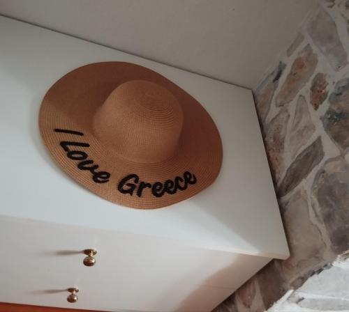 a hat sitting on top of a white tank at OLYMPUS HILL in Litochoro