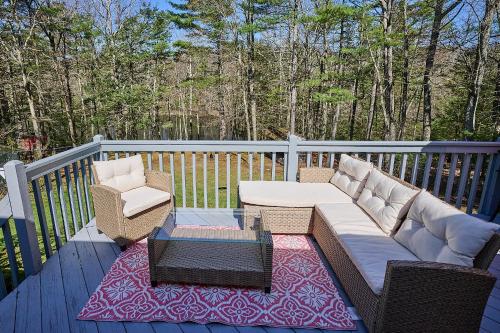 a patio with a couch and chairs on a deck at Spacious Catskills Serenity nearby Delaware River Gap w Game Rm Pet Friendly and Fenced Yard in Glen Spey