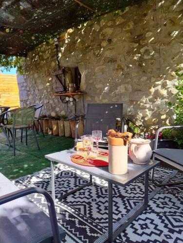 a table sitting on a tiled floor with at lou caladou gîte en pierre avec bain à remous in Vallon-Pont-dʼArc