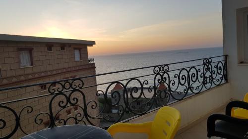 a balcony with chairs and a view of the ocean at Appartement bord de mer in Mazer