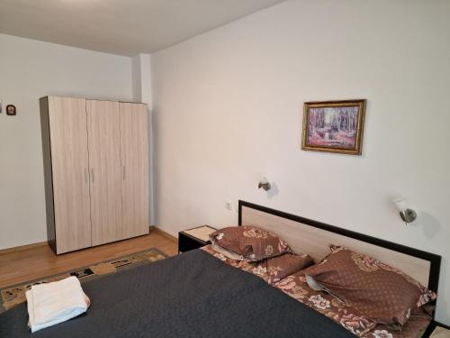 a bedroom with a bed and a cabinet in it at Къща за гости Пантови in Gramatikovo