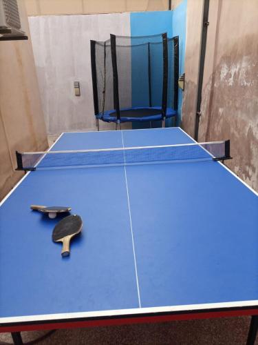 a ping pong table with a ping paddle on it at Julie Home Chalet in Madaba