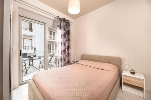 a bedroom with a bed and a balcony with a table at HyperCenter Diamond in Kos Town