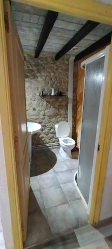 a bathroom with a toilet and a sink at Algarabiastaying 3 granja San Julián in Medina de Pomar
