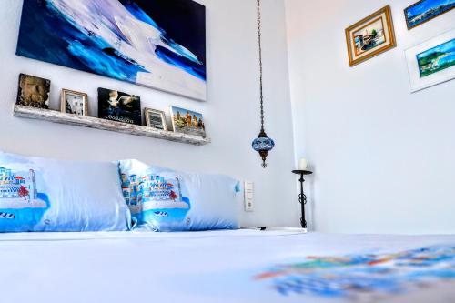 a bedroom with a white bed with blue pillows at BLUE, Traditional House in Klíma
