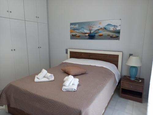 a bedroom with a bed with towels on it at Σπίτι δίπλα στην θάλασσα in Patra