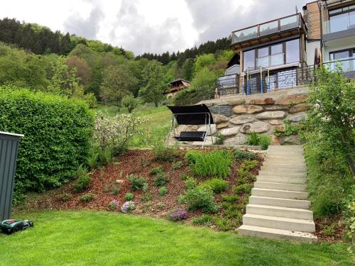 a house on a hill with a grass yard at Seehaus Weiss in Rothenthurn