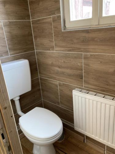 a bathroom with a white toilet and a radiator at Zur Baumwolle in Nürnberg