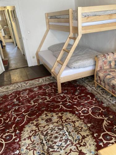 a room with two bunk beds and a rug at Zur Baumwolle in Nürnberg