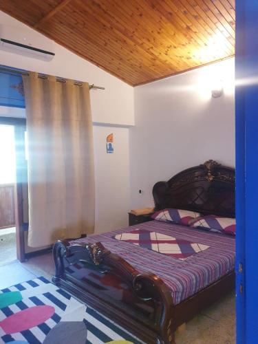 a bedroom with a bed with a wooden frame at Casa Plasa Grande chefchaouen in Chefchaouene