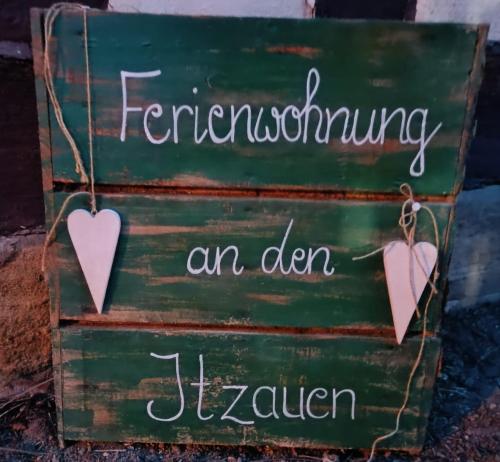 a green sign with two hearts on it at Ferienwohnung an den Itzauen in Großheirath