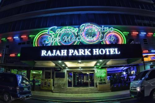 a raleigh park hotel at night with a neon sign at Rajah Park Hotel by Hiverooms in Cebu City