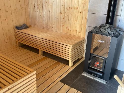 a sauna with a woodburning stove in a room at Plitvice Apis in Korenica