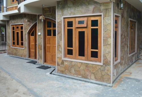 a row of wooden doors on the side of a building at Quinton Enclave in Shillong