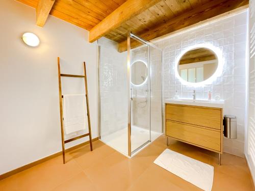 a bathroom with a shower and a sink and a mirror at La Maison de Léon in Saint-Georges-de-Gréhaigne