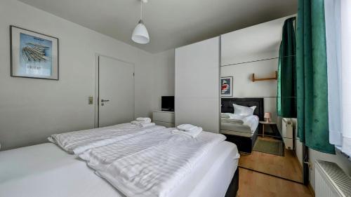 - une chambre blanche avec un grand lit blanc dans l'établissement Miramar-App-06, à Ahlbeck