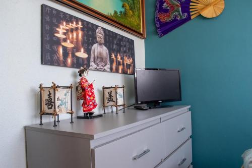 a dresser with a television on top of it at Oriental Belle Aire in Hemsby