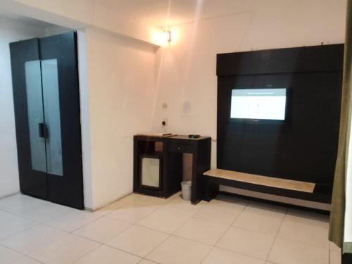 a bathroom with a black door and a sink at Hotel BLVD in Playa del Carmen