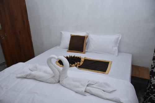two swans made out of towels on a bed at Dreaminn family homestay in Meenangadi