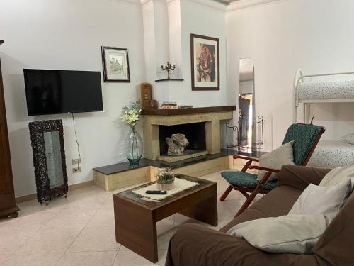 a living room with a couch and a fireplace at Sangio' Apartment in Lecce