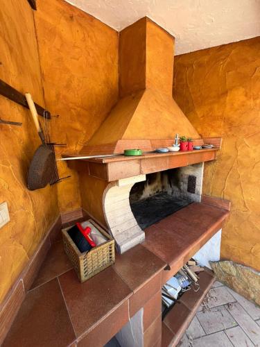 a kitchen with a stone oven in a room at Villa Azzurra Fronte Mare in Capitana