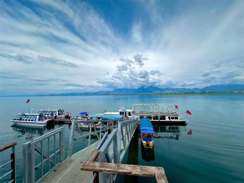 two boats are docked at a dock on a lake at Three Brothers in Široka