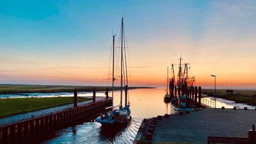 a group of boats are docked in the water at AAR Nordsee Appartement in Varel