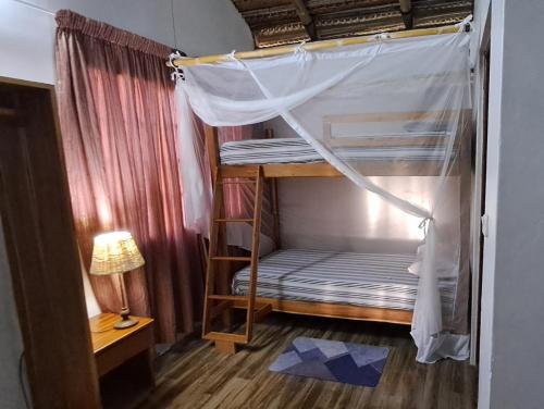 a bunk bed with a canopy in a room at Venha Juntos Guest Homes in Miramar